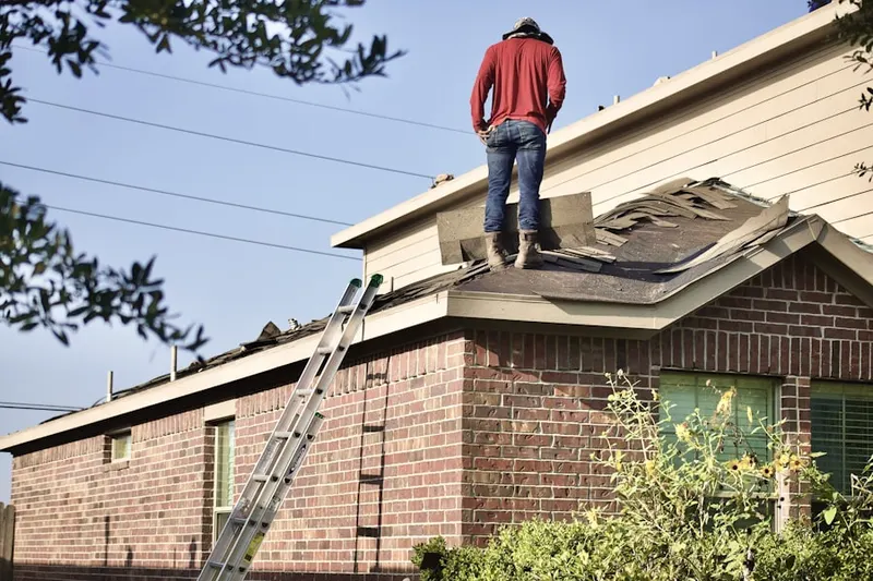 Professional roofer working on a residential roof in Perrine